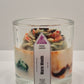 Candle in a glass jar with a label Warm Woods on a white background