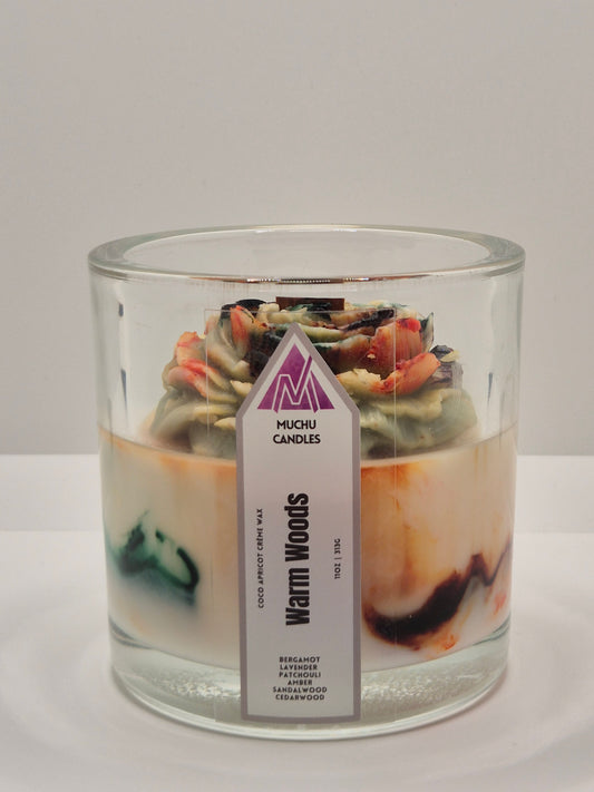 Candle in a glass jar with a label Warm Woods on a white background