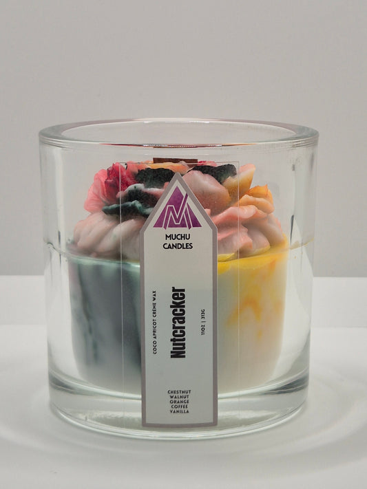 Candle in a glass jar with a visible label called Nutcracker on a white background